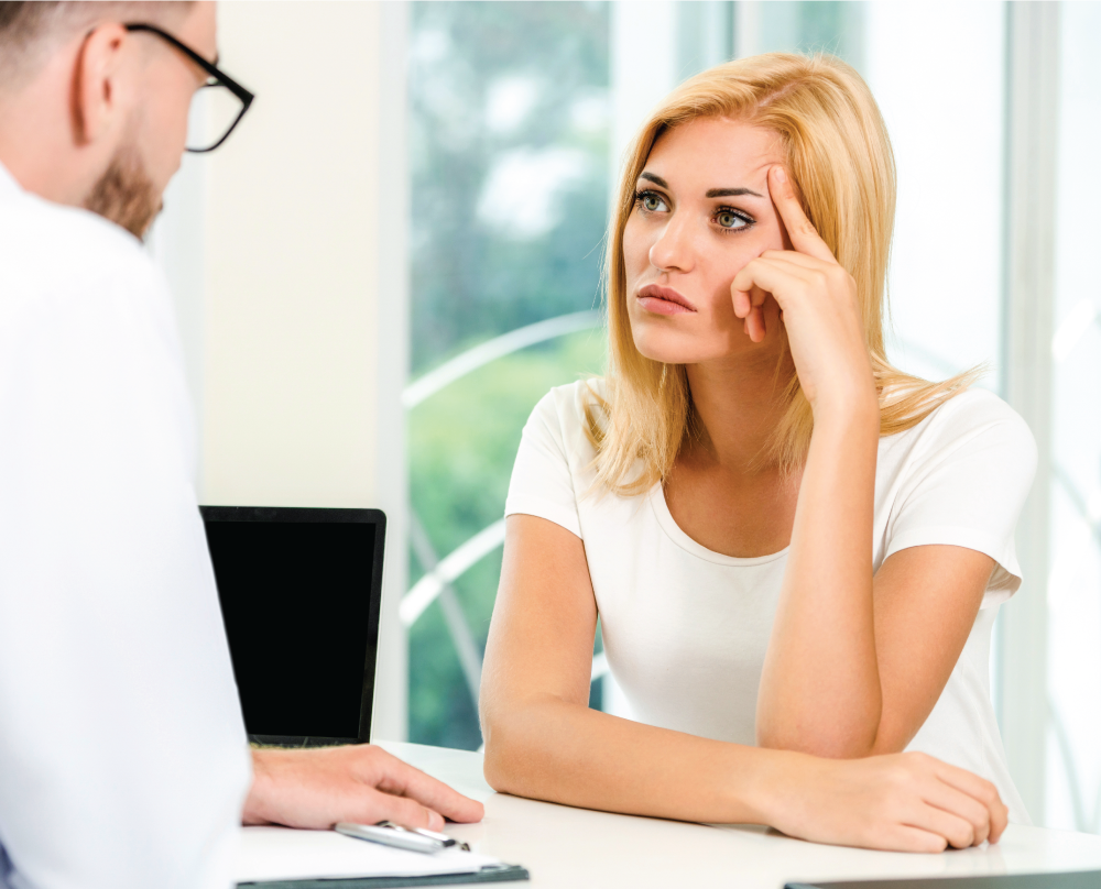 Woman receiving frustrating news from a medical professional